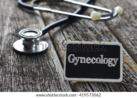 Medical Concept- Gynecology word written on blackboard with Stethoscope on wood background
