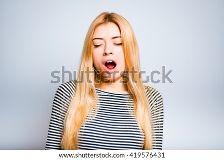 Pretty blond girl yawning, tired