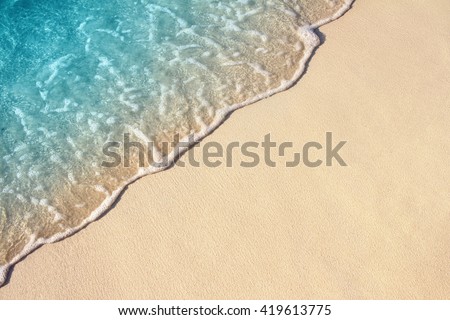Soft Wave Of Blue Ocean On Sandy Beach. Background. Selective focus.