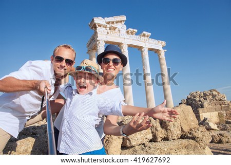 Positive young family take a selfie photo near antique Temple of Apollo,Side,Turkey