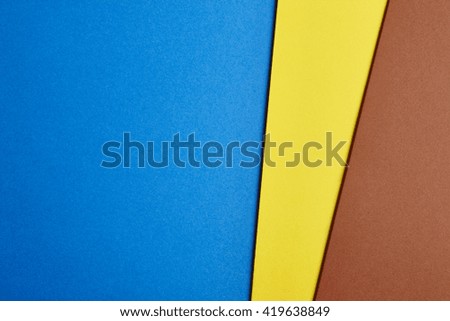 Colored cardboards background in blue yellow brown tone. Copy space. Horizontal