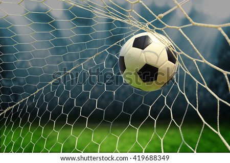 soccer ball in goal with spotlight Royalty-Free Stock Photo #419688349