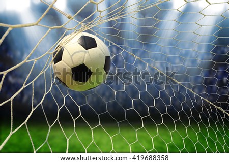 soccer ball in goal with spotlight Royalty-Free Stock Photo #419688358