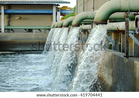 Water flows from a pipe for cooling of machine. Royalty-Free Stock Photo #419704441