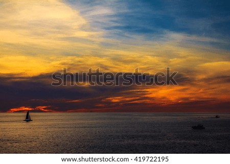Sunset.
Beautiful summer sunset over ocean with the clouds, changing different colors. From blue to, yellow, orange, purple....