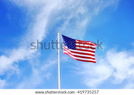 USA flag on blue sky close up
