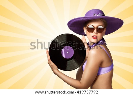Beautiful pinup bikini model wearing sunglasses and hat, holding an LP microgroove vinyl record on colorful abstract cartoon style background.