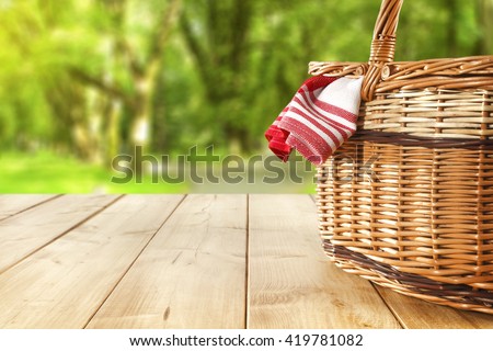red napkin picnic basket and table place  Royalty-Free Stock Photo #419781082