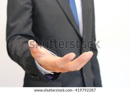 Businessman opening his hand palm on white background
