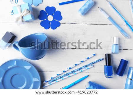 Blue colour flat lay composition on white wooden background