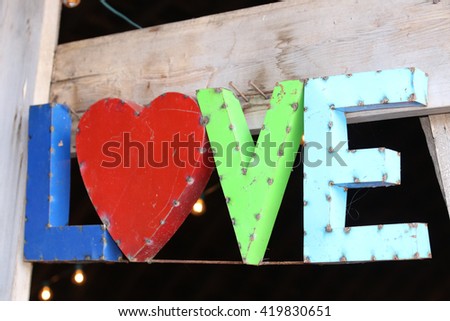 Vintage love metal sign wedding decoration hanging in barn for country wedding.