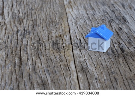 model of house as symbol on wooden background