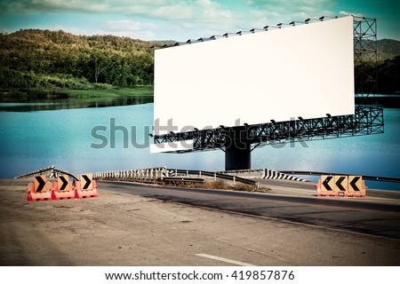 billboard and bridge with lake and mountain background