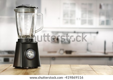 blender and wooden table in kitchen  Royalty-Free Stock Photo #419869516