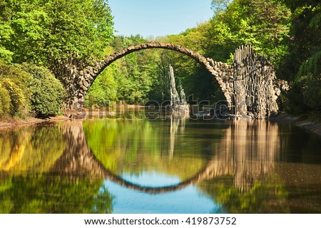 Rakotzbrucke also known as DevilÃ¢??s Bridge in Kromlau in Germany. Reflection of the bridge in the water create a full circle. Royalty-Free Stock Photo #419873752