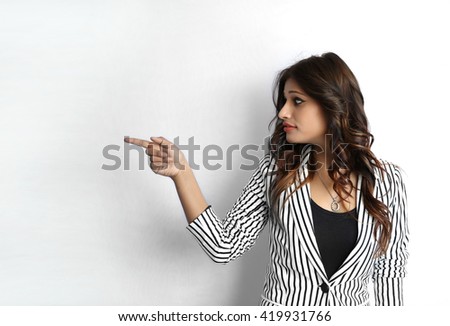 Attractive beautiful young Indian business woman pointing her finger gesture isolated on white background