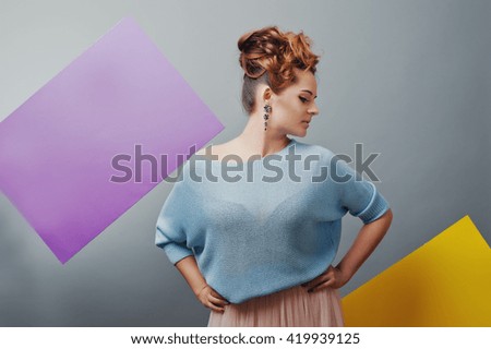 Studio portrait of young girl near art colored blanks.