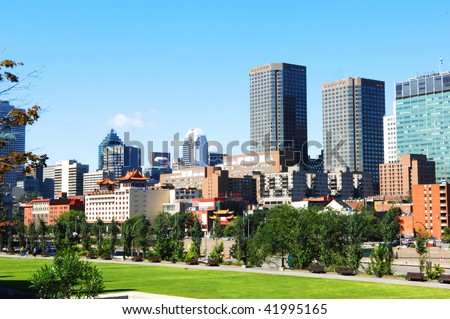 The skyline of Montreal with old harbor park and china town in foreground.