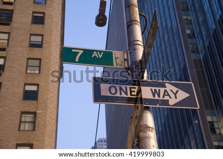 "7th Avenue" and "one way" signs in front of the buildings at Manhattan, New York