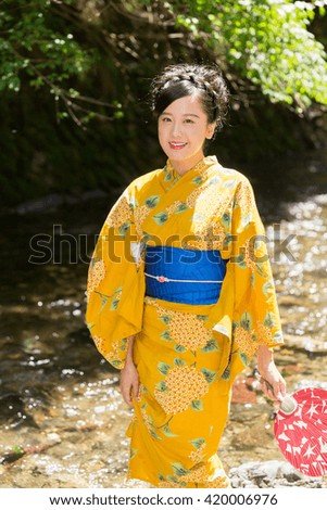 attractive asian woman wearing traditional Japanese casual summer kimono called "Yukata".