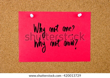 Red paper note with handwritten text Why Not Me, Why Not Now pinned on cork board with white thumbtacks