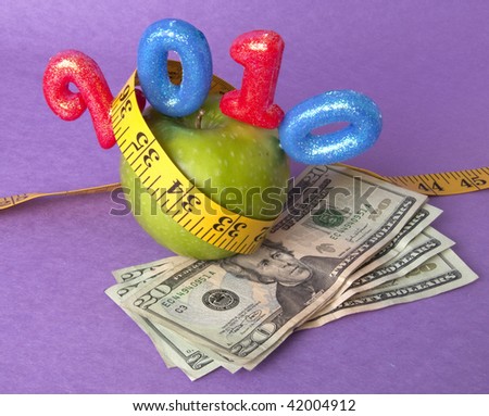 Granny Smith Green Apple with a bright yellow tape measure represents the concepts of the cost of diet and healthy lifestyle. Also works for a high cost of healthcare or education concept.
