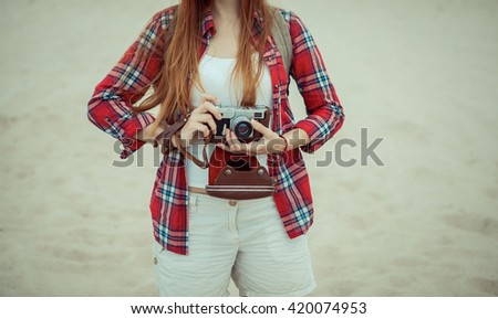 Redhead girl walking through a desert. Travel concept