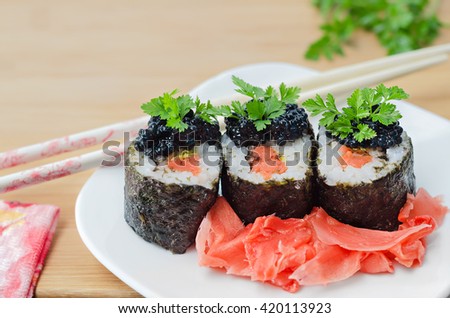 Rolls with salmon, caviar and pickled ginger