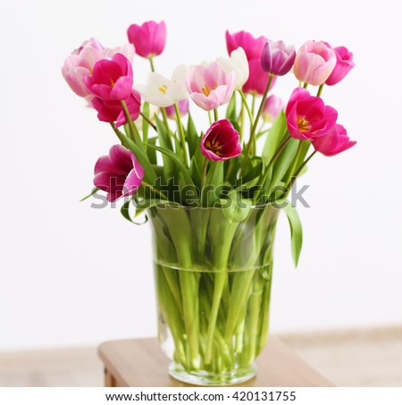 Bouquet of beautiful tulips on white wall background