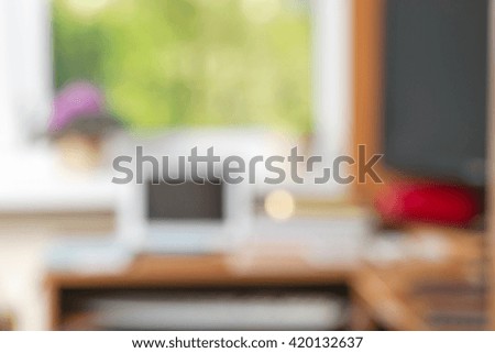 Abstract office desk table with computer, supplies, flower blur background. Copy space for text.