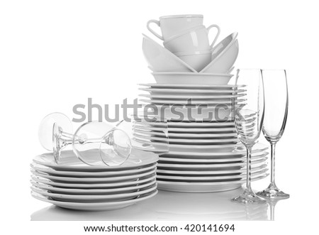Stacked white clean plates, glasses and cups isolated on white