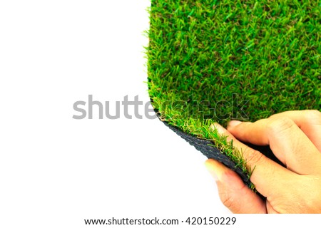 Hand open artificial grass with copy space for text on white background (selective focus)