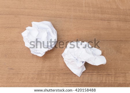paper ball white sheet crumpled lumpy on wooden floor background