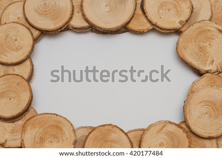 Frame of wood. Plate made of wooden circles. Frame for photos of wooden ends on a white background.