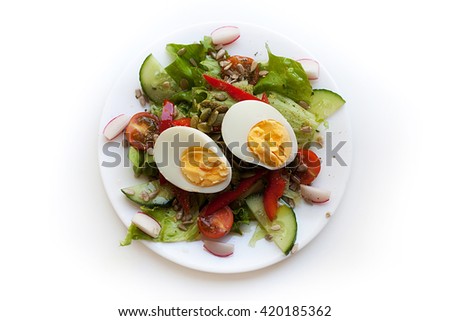 Green mixed salat. Vegetable salad with egg, sunflower and pumpkin seeds. Isolated on white background. Royalty-Free Stock Photo #420185362