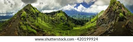 Mount Batur one of the famous volcanos in tropical island Indonesia / Batur volcano and Batur lake, panoramic view / Bali, Indonesia