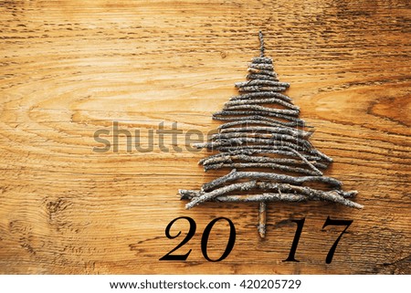 Sign symbol from many dry Stick Christmas green Tree. a lot trunk lie on old retro vintage style wooden texture background. Empty copy space for inscription. Idea of merry new year 2017 holiday