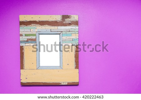 Empty vintage frame isolated on pink cement wall.