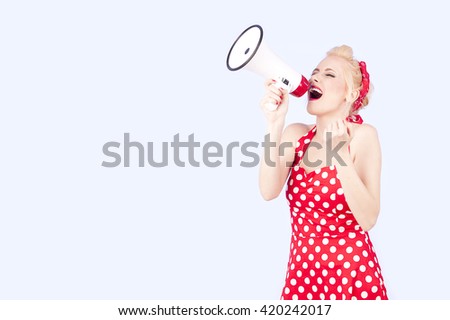Portrait of woman holding megaphone, dressed in pin-up style red dress 