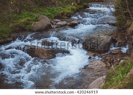 The picturesque mountain waterfall. Spring in mountains