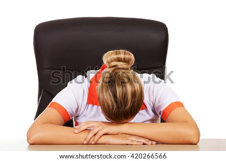 Tired young female doctoror nurse sleeping on the desk