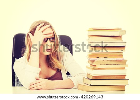 Young woman with a books pile