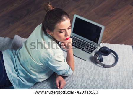 Woman with a laptop at her home