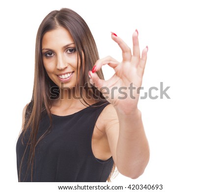 Beautiful young smiling woman showing Ok sign, isolated on white background