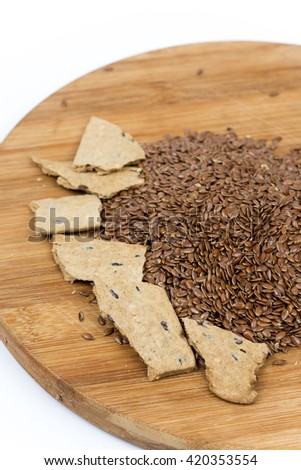 Flax seeds with flax snacks on the board.