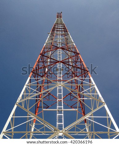 Newly completed telecommunication tower with blue sky as background.