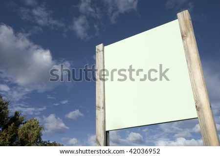 green signboard with blue sky