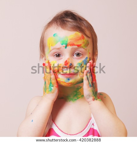 beautiful  little baby girl doing make up (humorous picture)
