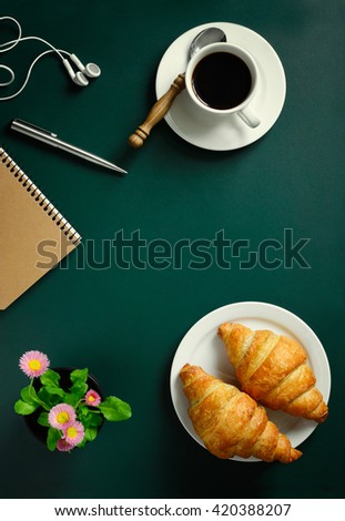 Chalkboard or table with coffee and croissants for breakfast, copy space for a text, top view, stylized image