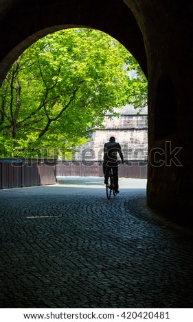 Silhouette of a biker in tunnel, Kaiserburg castle and Nuremberg